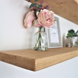 Handmade rustic wooden floating shelf with a sleek design.